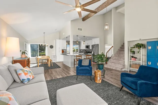 a living room with furniture and kitchen view