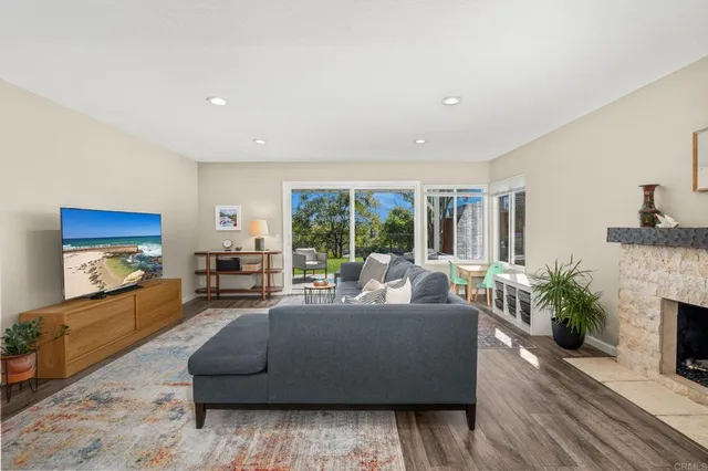 a bedroom with a bed a chandelier and a couch