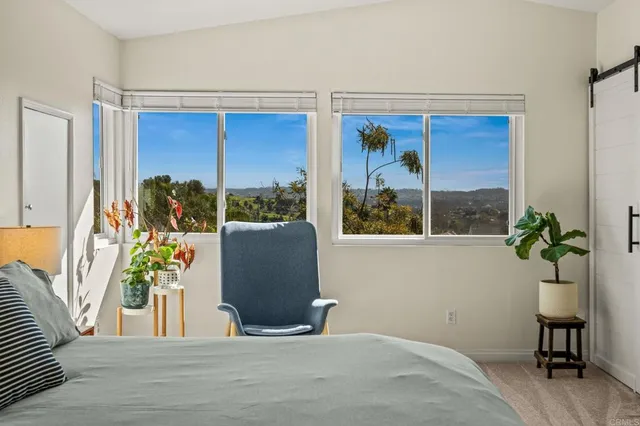 a bedroom with a bed and a desk