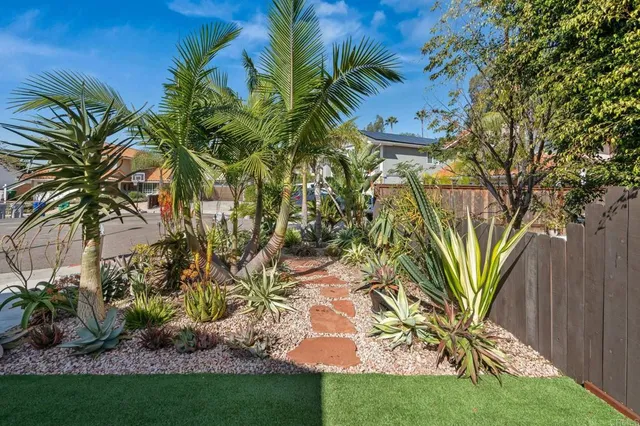 a view of house with backyard and sitting area