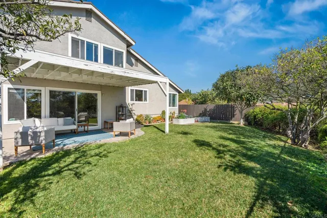 a view of a patio with couches chairs and a big yard
