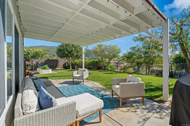 a view of a patio with couches and a big yard