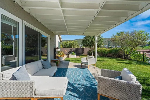 a view of a chair and table in the garden