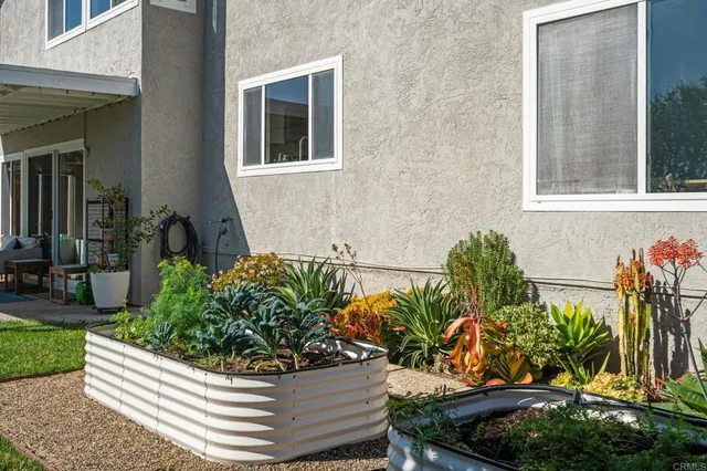 a view of a chair and table in backyard of the house