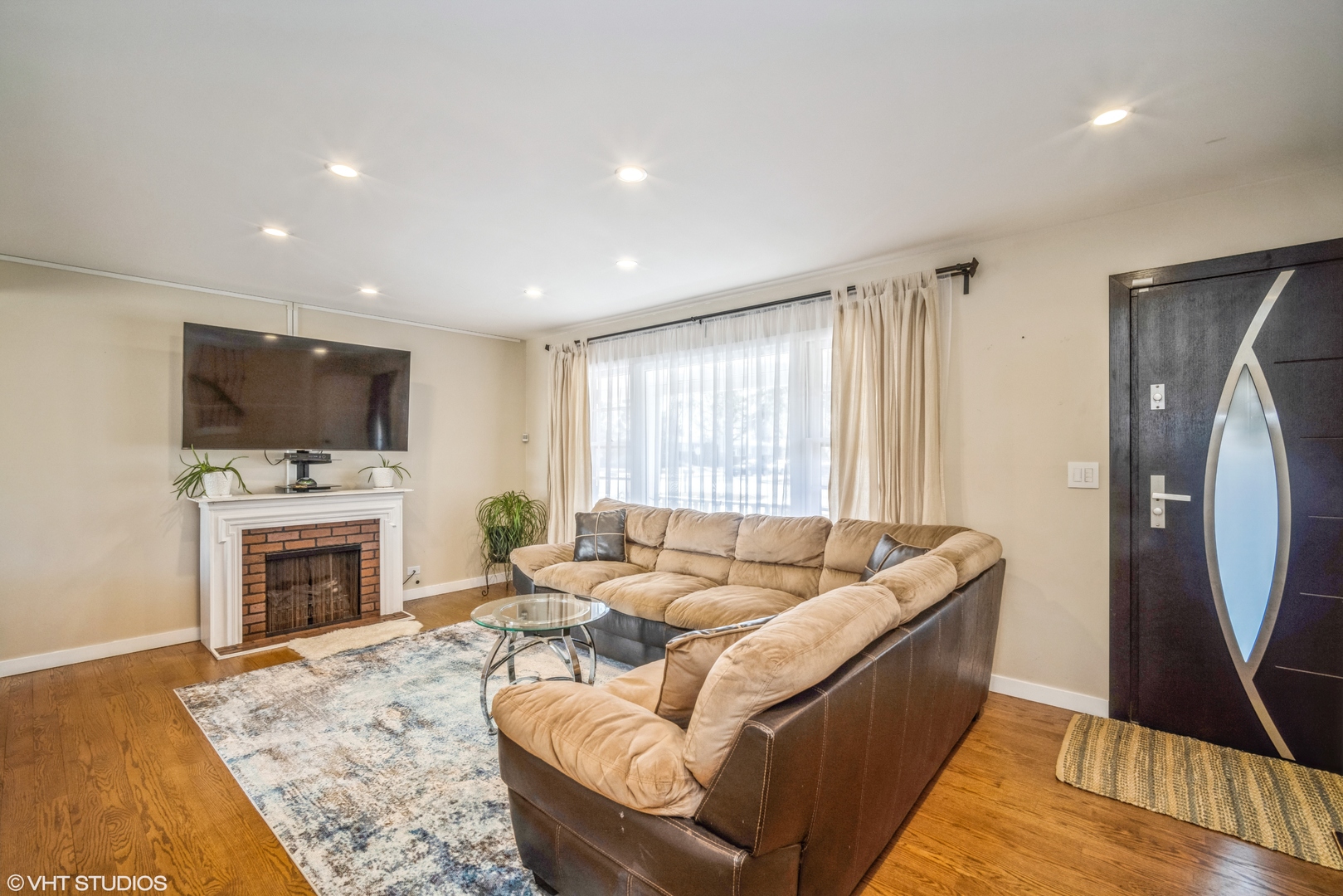 420 West Kensington Road Mount Prospect, IL 60056 - Photo 5 of 13 a living room with furniture flat screen tv and a fireplace