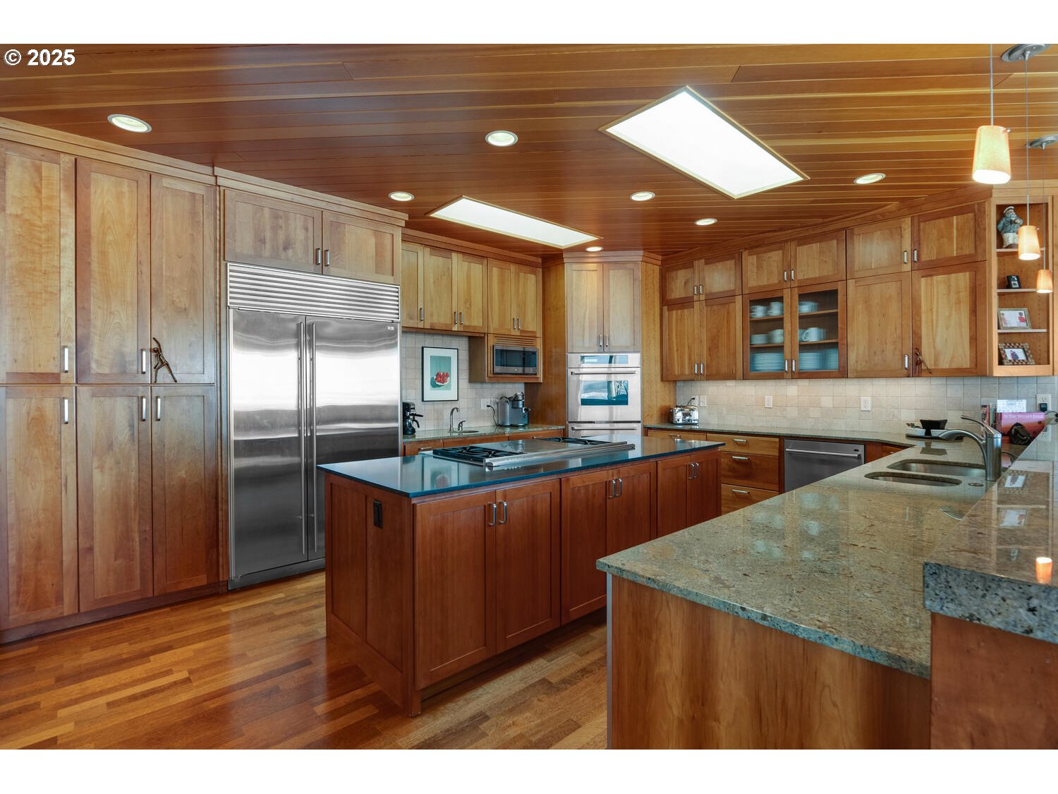 1880 Pacific Avenue Cannon Beach, OR 97110 - Photo 17 of 48 a kitchen with stainless steel appliances granite countertop a sink a refrigerator and a granite counter tops