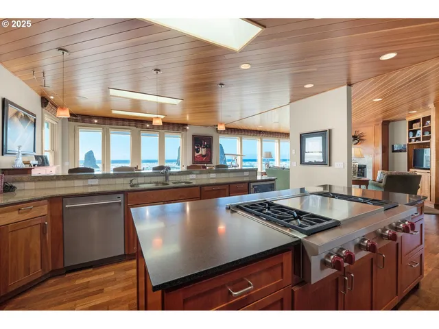 a kitchen with stainless steel appliances granite countertop a sink stove and cabinets