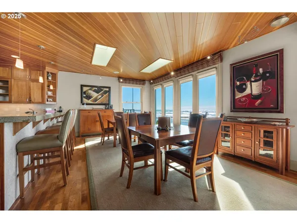 a view of a dining room with furniture and chandelier