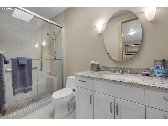 a bedroom with furniture and a large window