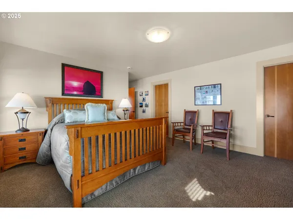 a bedroom with a bed and a large window