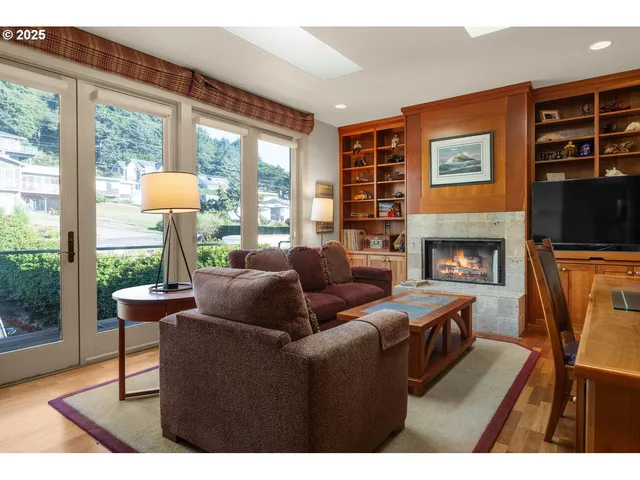 a living room with furniture a table and a large window