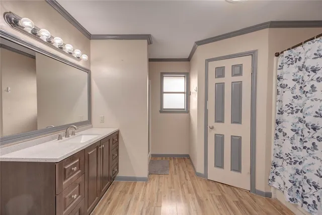 a bathroom with a double vanity sink a mirror and a shower