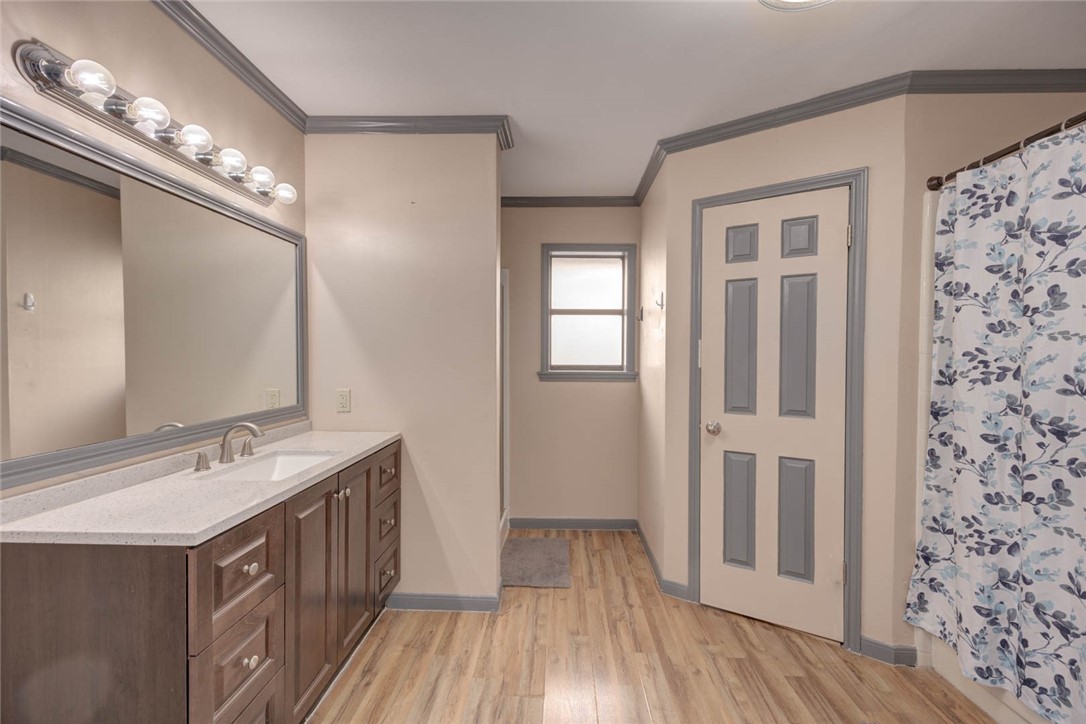 4737 Spring Fork Drive Corpus Christi, TX 78413 - Photo 18 of 37 a bathroom with a double vanity sink a mirror and a shower