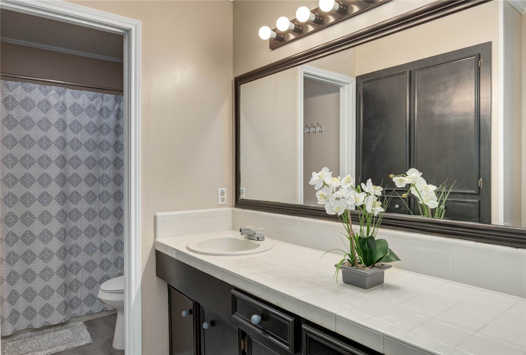 4737 Spring Fork Drive Corpus Christi, TX 78413 - Photo 27 of 37 a bathroom with a sink a vanity and a mirror