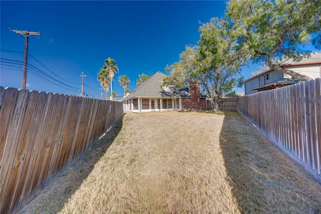a view of a house with a wooden fence