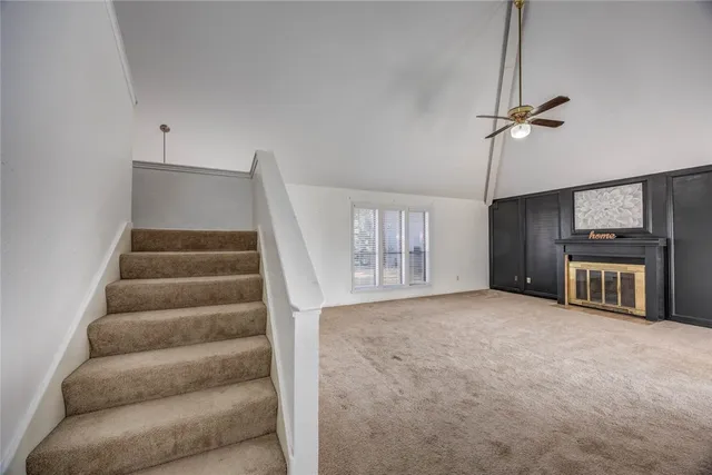 a view of an empty room with a fireplace