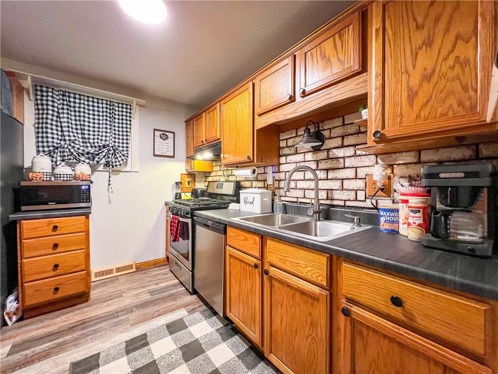 178 Hoon Road Butler, PA 16001 - Photo 5 of 26 a kitchen with stainless steel appliances granite countertop a stove and a sink