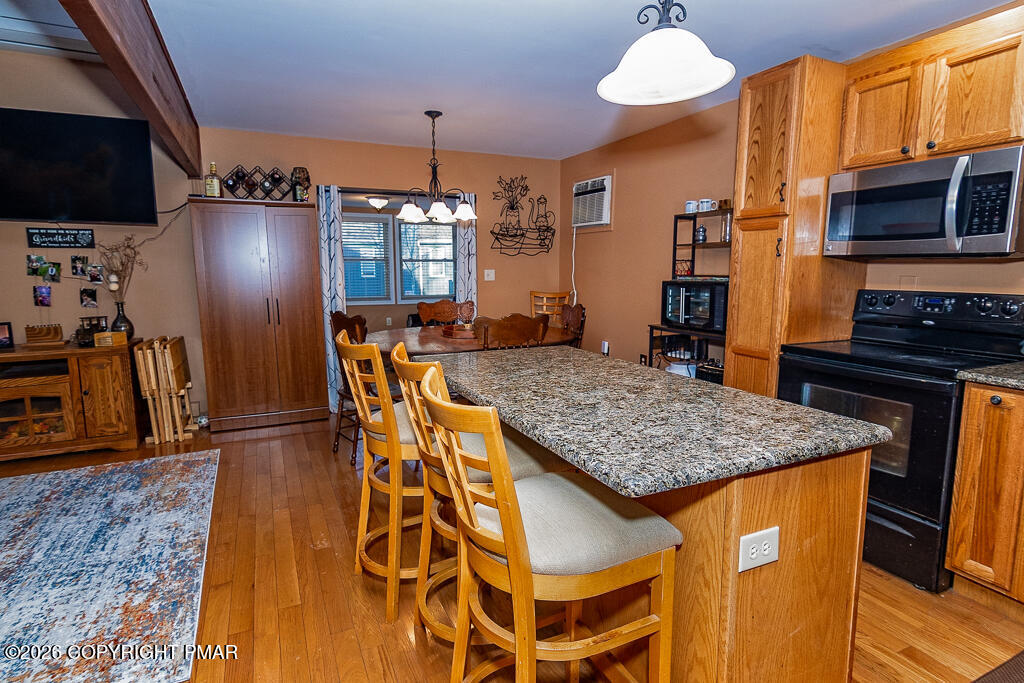 122 Dover Drive Bushkill, PA 18324 - Photo 15 of 45 a kitchen with stainless steel appliances granite countertop a stove and a refrigerator