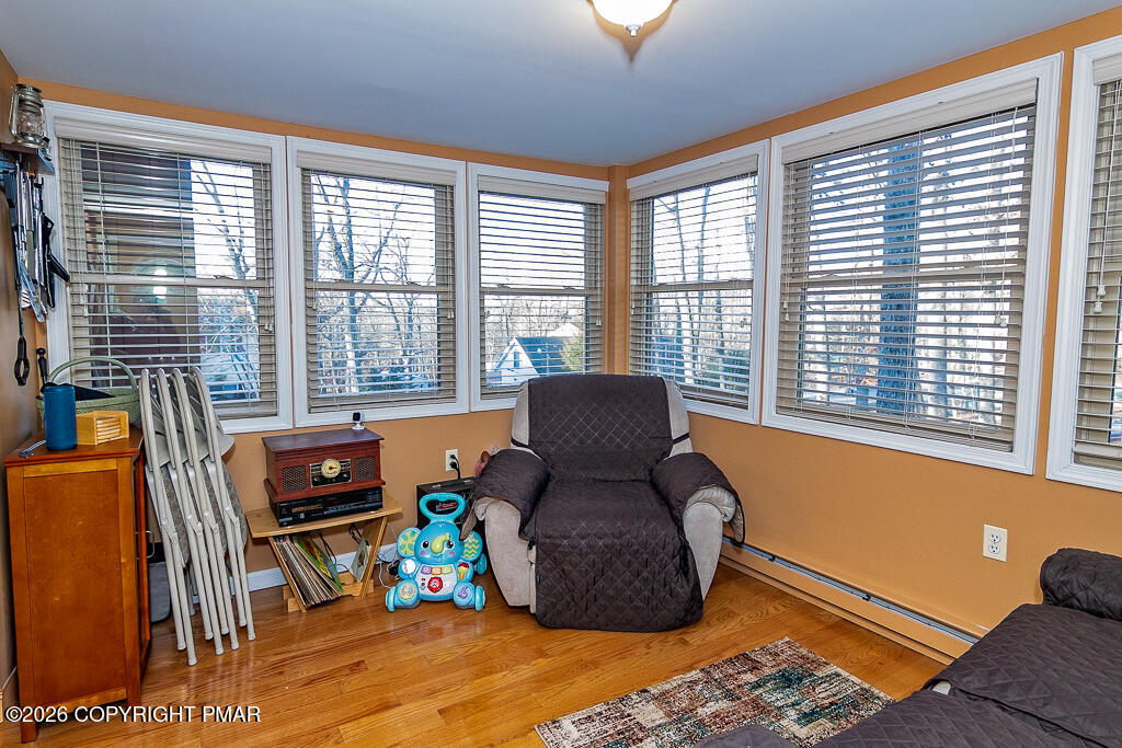 122 Dover Drive Bushkill, PA 18324 - Photo 18 of 45 a living room with furniture and a floor to ceiling window