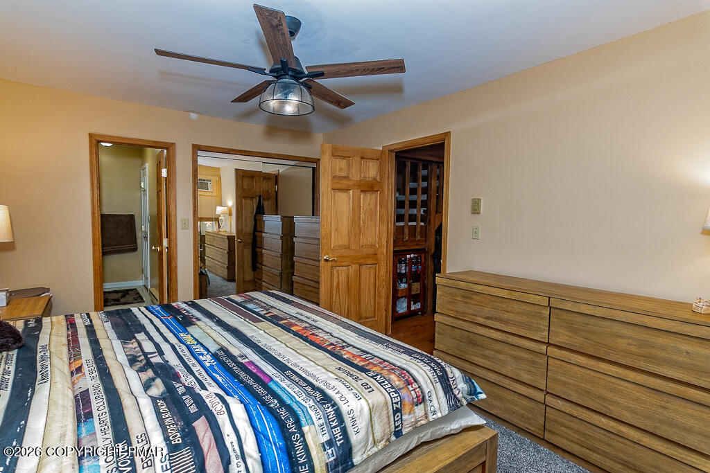 122 Dover Drive Bushkill, PA 18324 - Photo 21 of 45 a bedroom with a bed and a chandelier