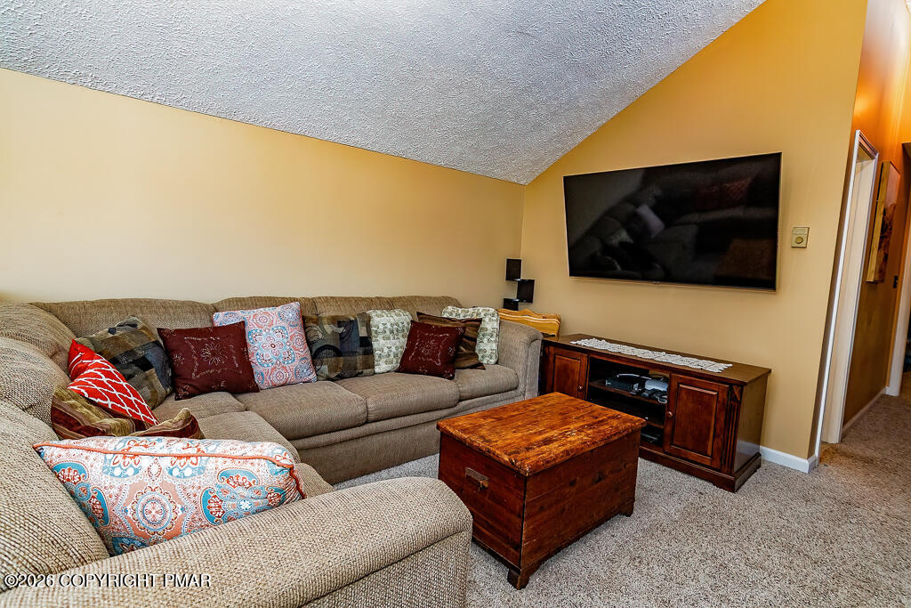 122 Dover Drive Bushkill, PA 18324 - Photo 31 of 45 a living room with a couch and a flat screen tv