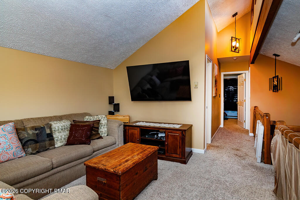 122 Dover Drive Bushkill, PA 18324 - Photo 32 of 45 a living room with furniture and a flat screen tv