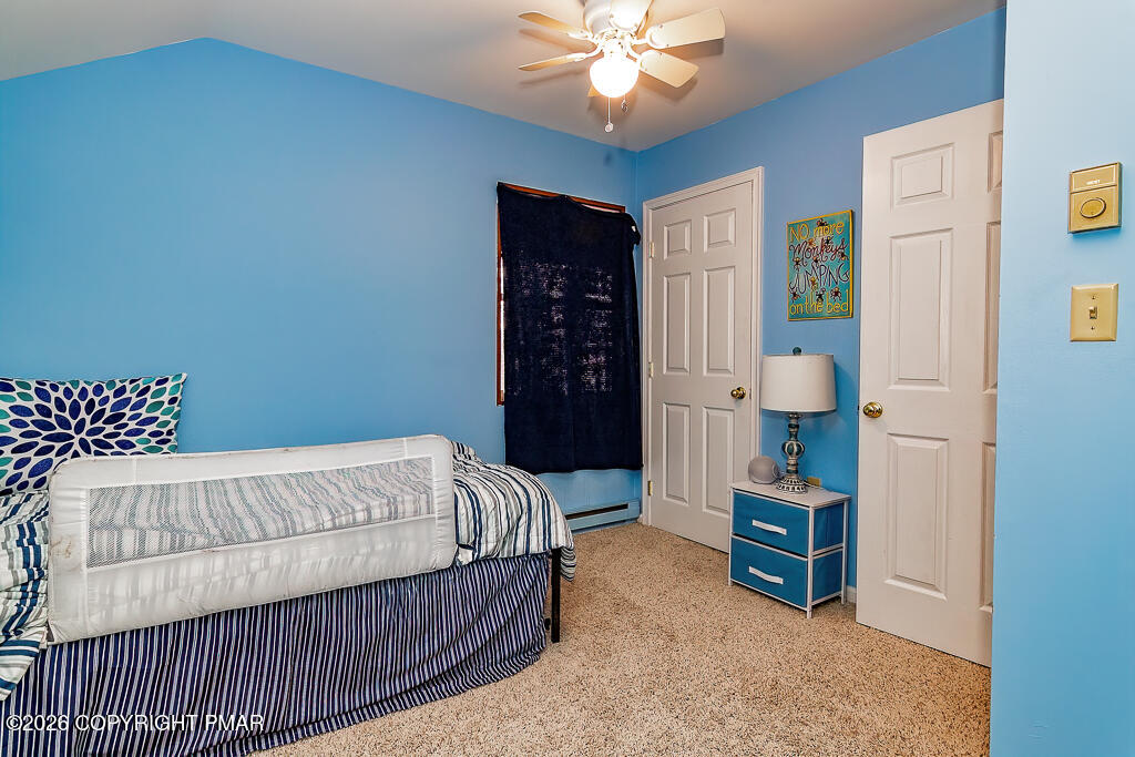 122 Dover Drive Bushkill, PA 18324 - Photo 37 of 45 a bed sitting in a room next to a lamp and closet