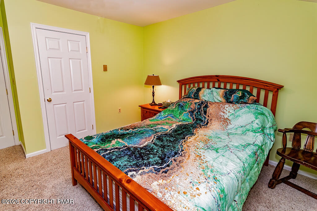 122 Dover Drive Bushkill, PA 18324 - Photo 39 of 45 a bed sitting in a bedroom next to a bathroom