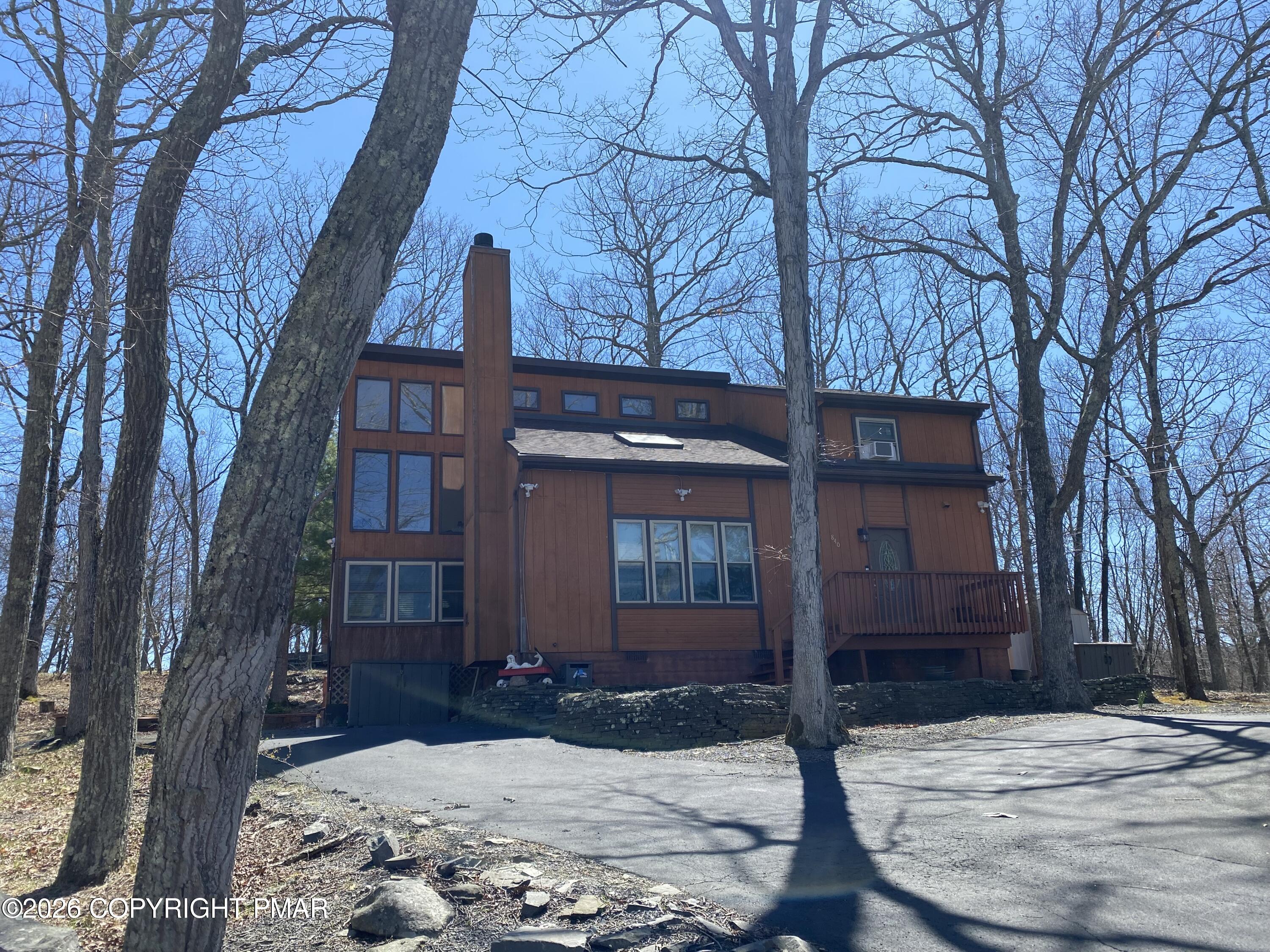 122 Dover Drive Bushkill, PA 18324 - Photo 48 of 49 a view of a brick house with a large tree