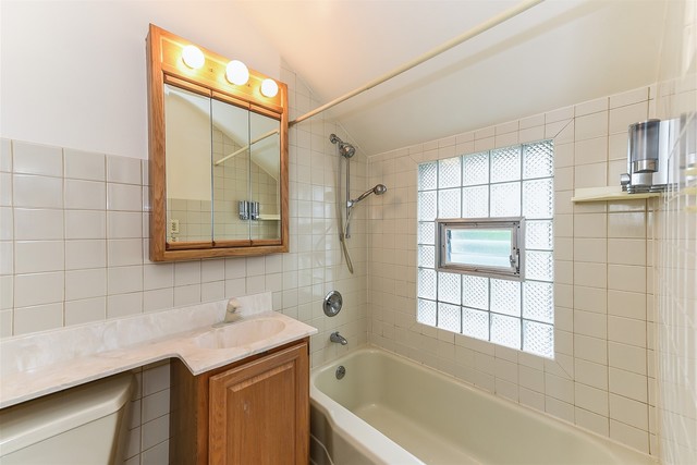 333 South Wolf Road Des Plaines, IL 60016 - Photo 19 of 25 a bathroom with a granite countertop sink a toilet and shower