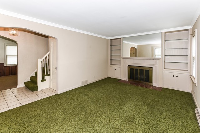 333 South Wolf Road Des Plaines, IL 60016 - Photo 3 of 25 a view of an empty room with a fireplace and a window