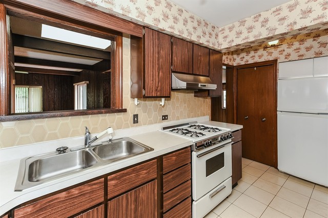333 South Wolf Road Des Plaines, IL 60016 - Photo 7 of 25 a kitchen with a sink stove and refrigerator