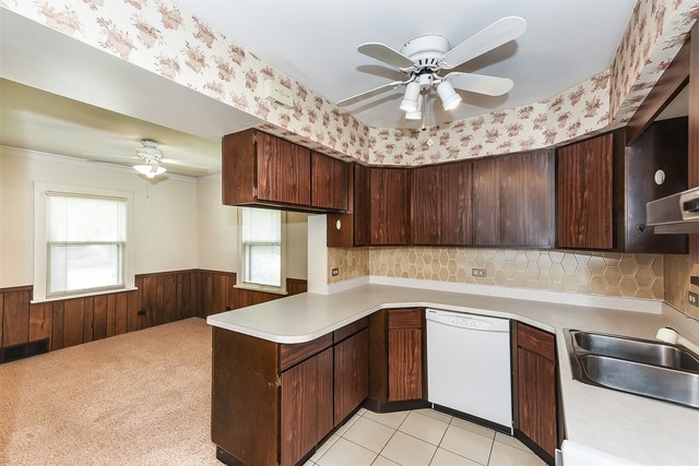 333 South Wolf Road Des Plaines, IL 60016 - Photo 8 of 25 a kitchen with a sink a stove and cabinets