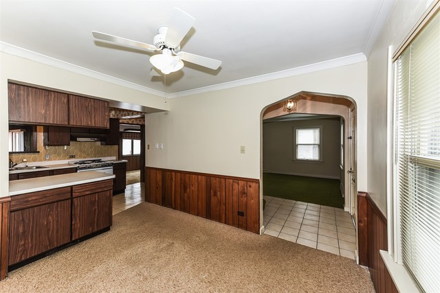 333 South Wolf Road Des Plaines, IL 60016 - Photo 10 of 25 a kitchen with stainless steel appliances granite countertop a stove cabinets and wooden floor