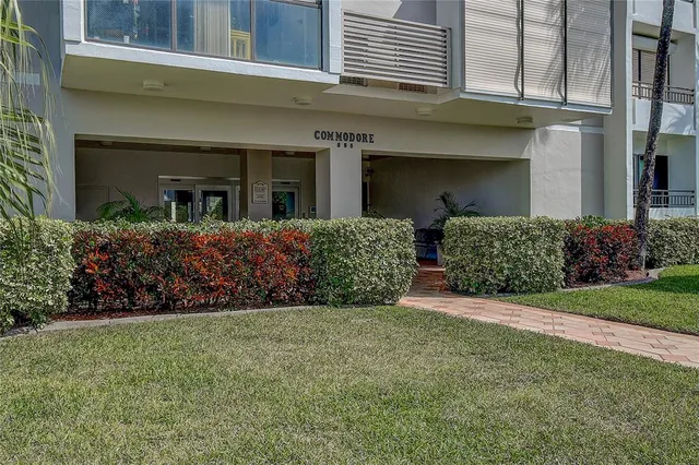 a view of a hallway with wooden floor and a living room