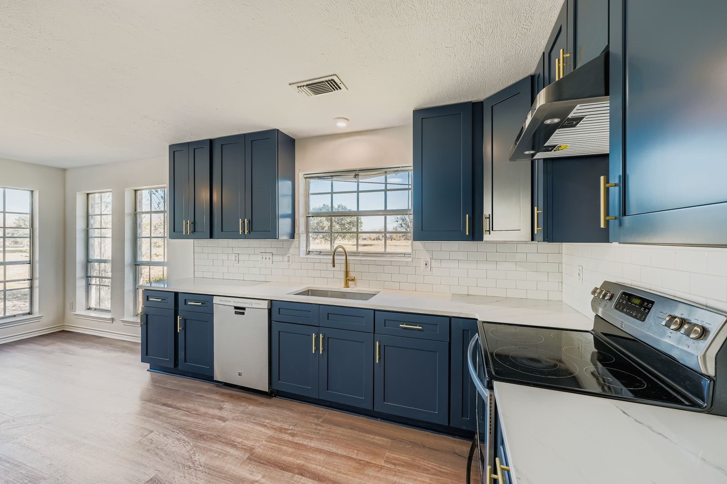 34411 Fulshear Farms Road Fulshear, TX 77441 - Photo 11 of 29 a kitchen with stainless steel appliances granite countertop a sink and a stove