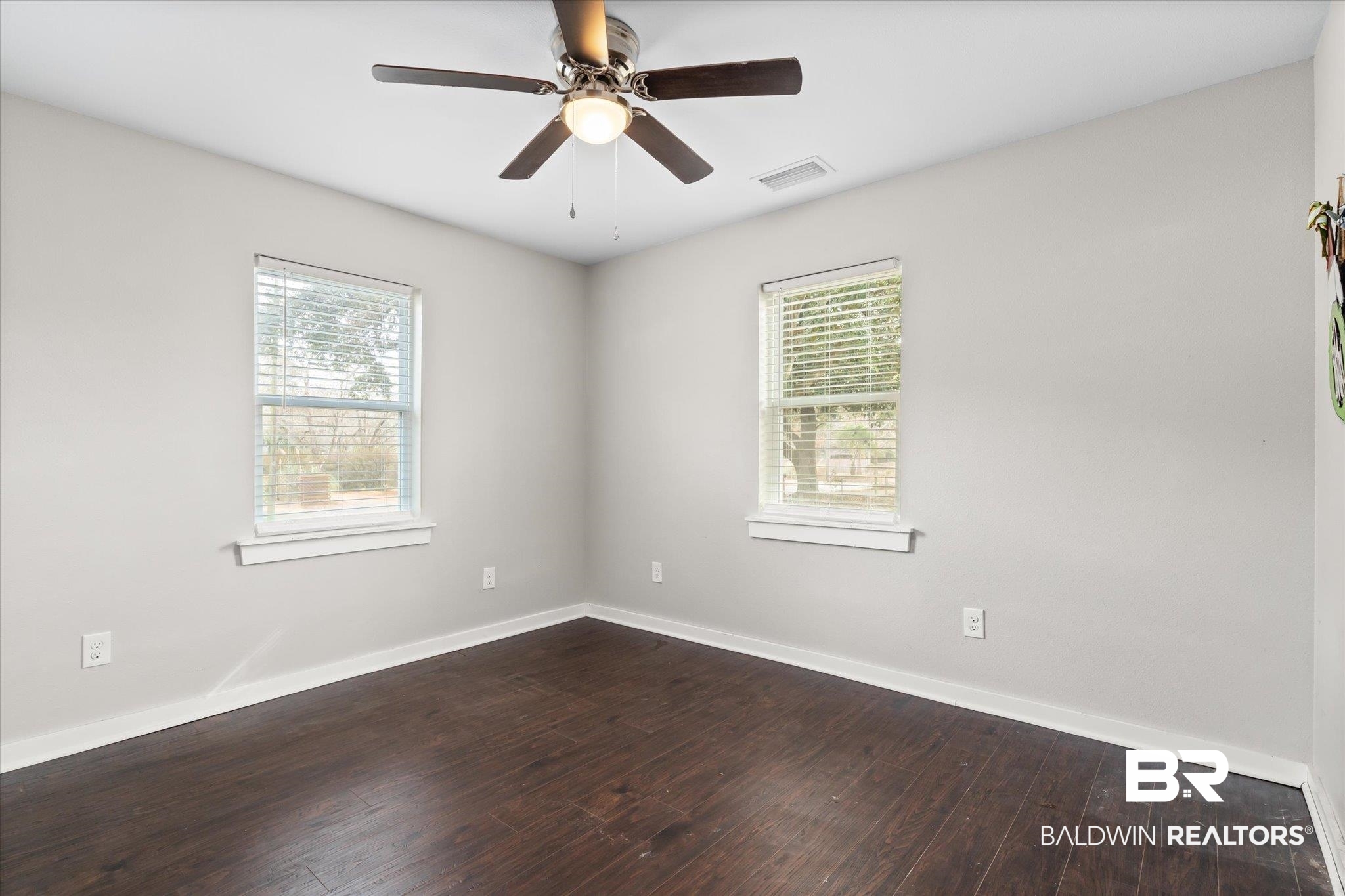 419 Pierce Street Saraland, AL 36571 - Photo 12 of 21 Unfurnished room featuring hardwood / wood-style flooring, plenty of natural light, and ceiling fan