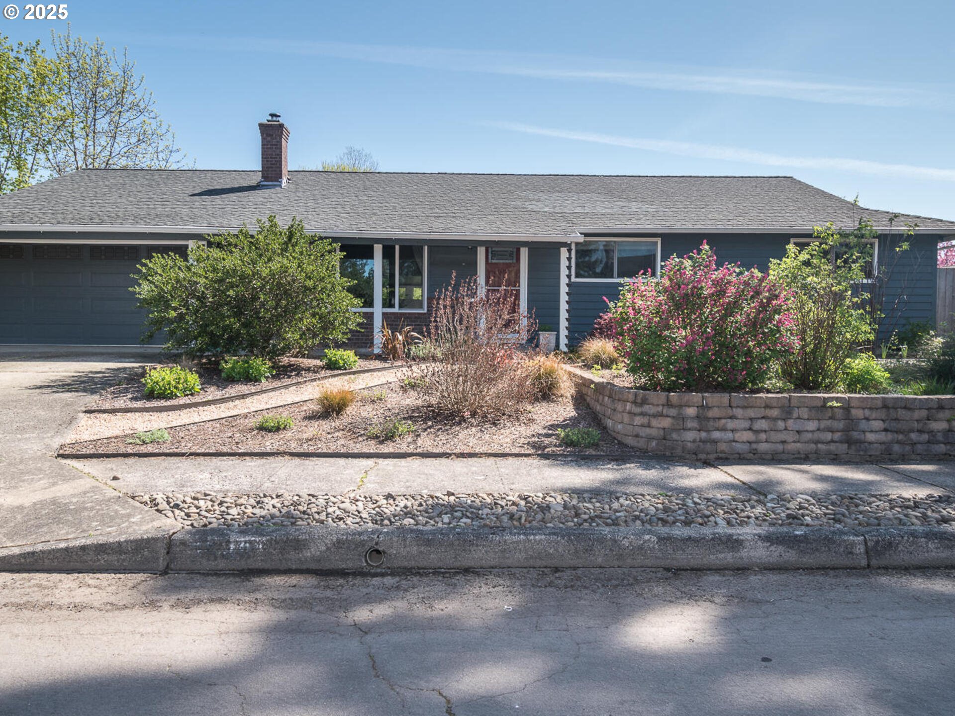 a front view of a house with a yard and a garage