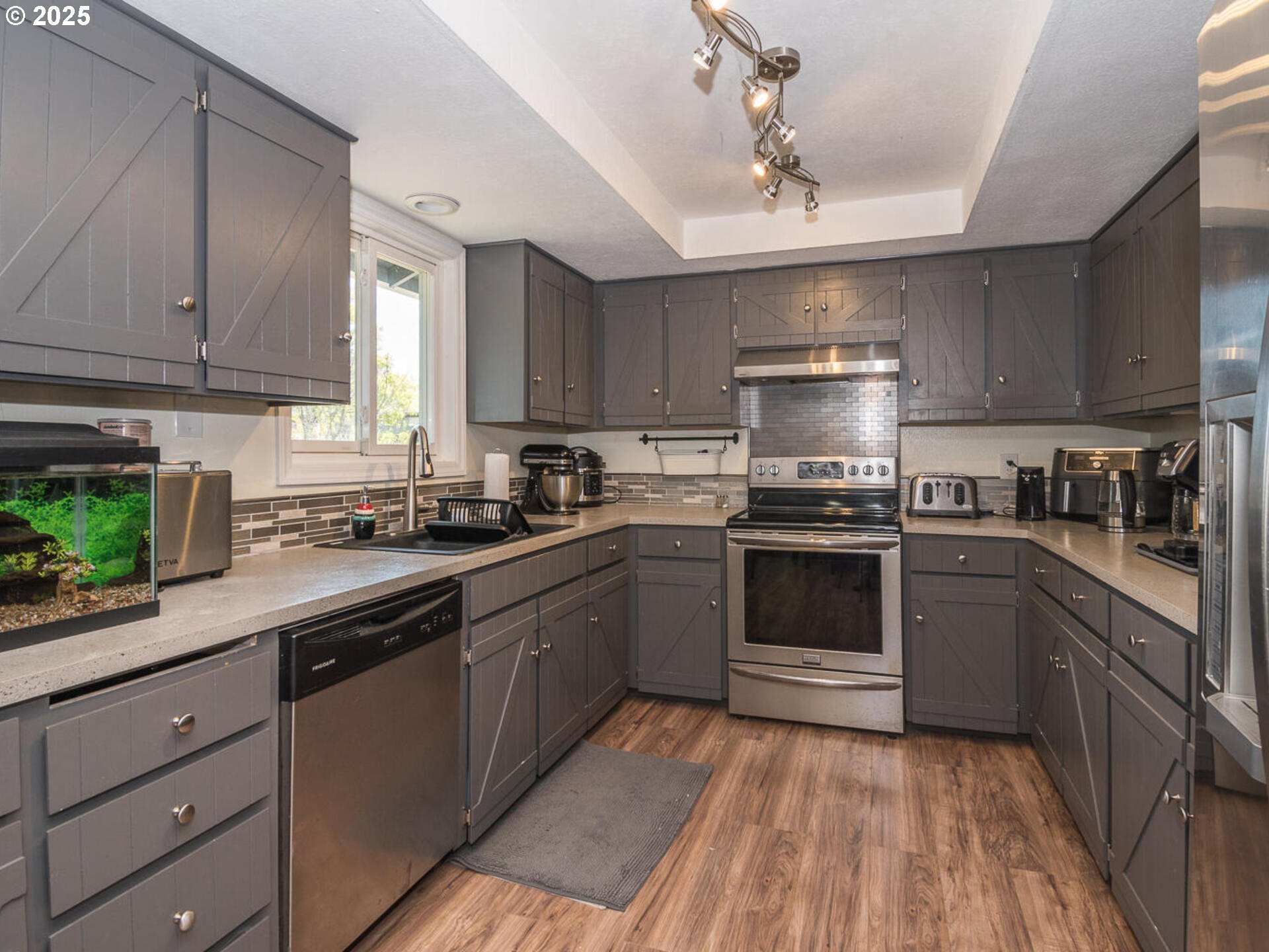 2548 Southeast Eagle Avenue Gresham, OR 97080 - Photo 16 of 32 a kitchen with granite countertop a sink stainless steel appliances and cabinets