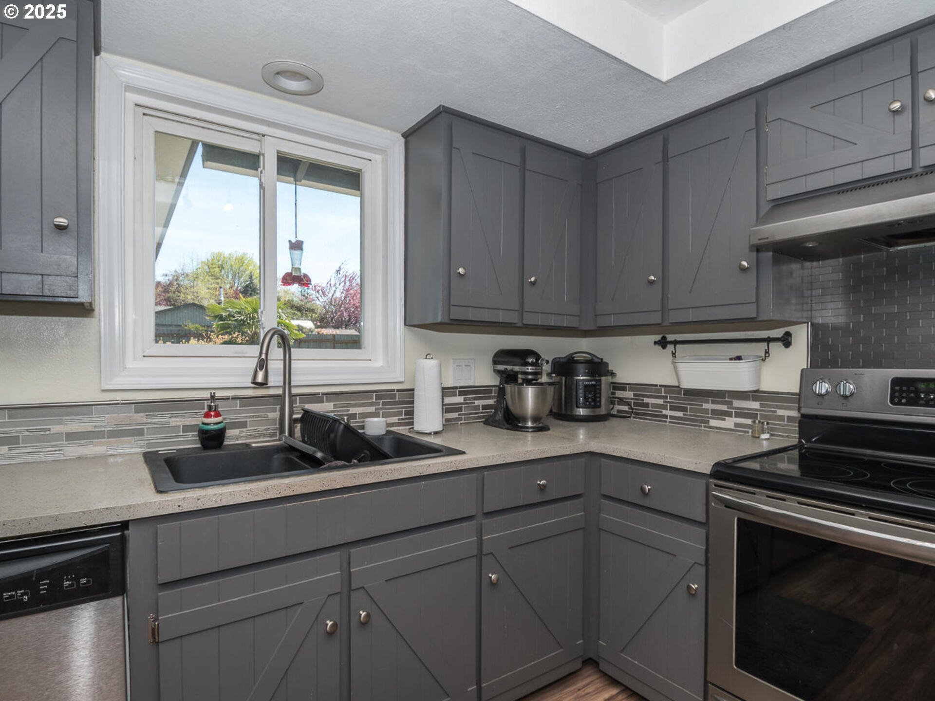 2548 Southeast Eagle Avenue Gresham, OR 97080 - Photo 17 of 32 a kitchen with sink cabinets and window