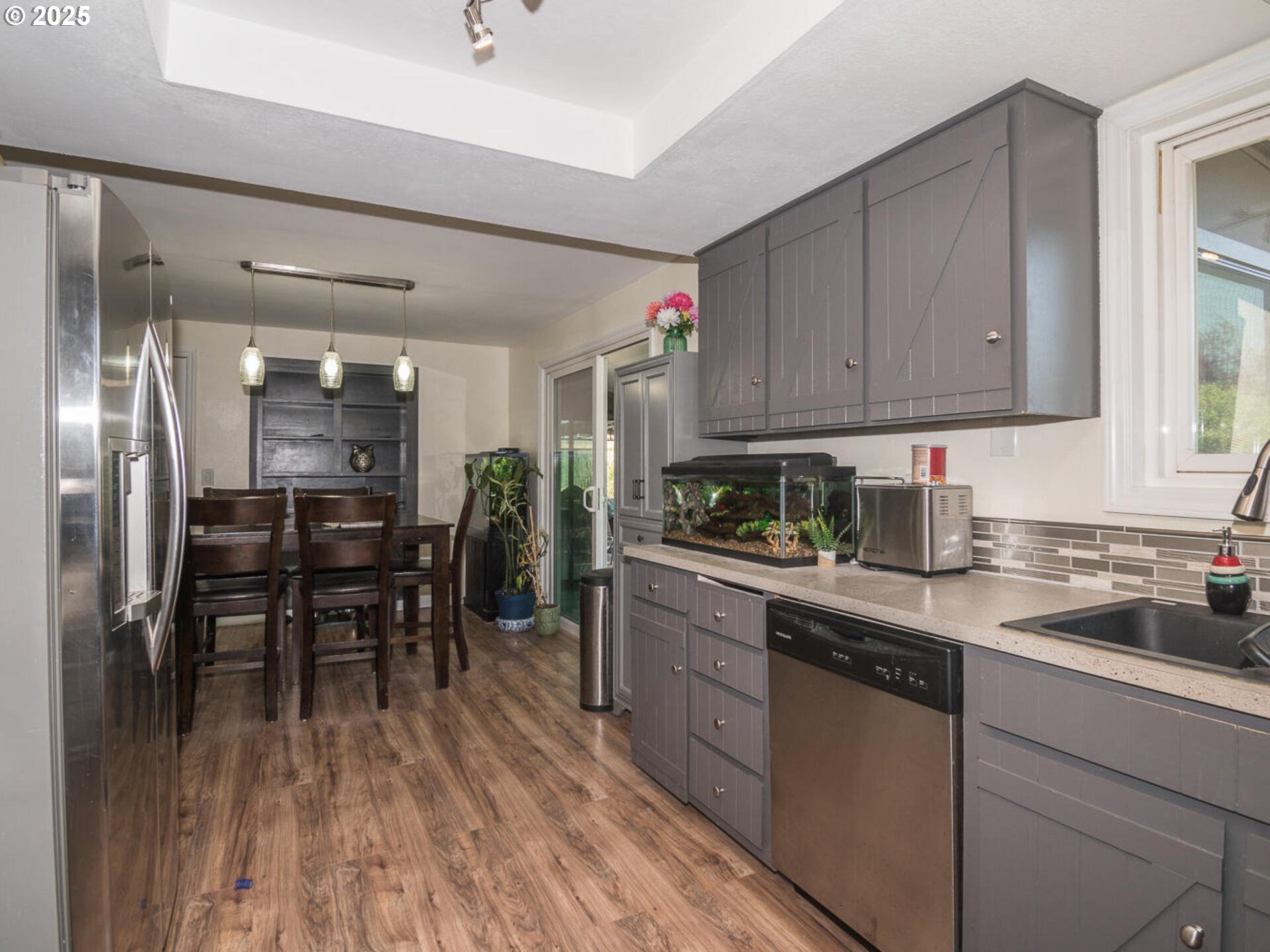 2548 Southeast Eagle Avenue Gresham, OR 97080 - Photo 20 of 32 a kitchen with granite countertop appliances cabinets and wooden floor