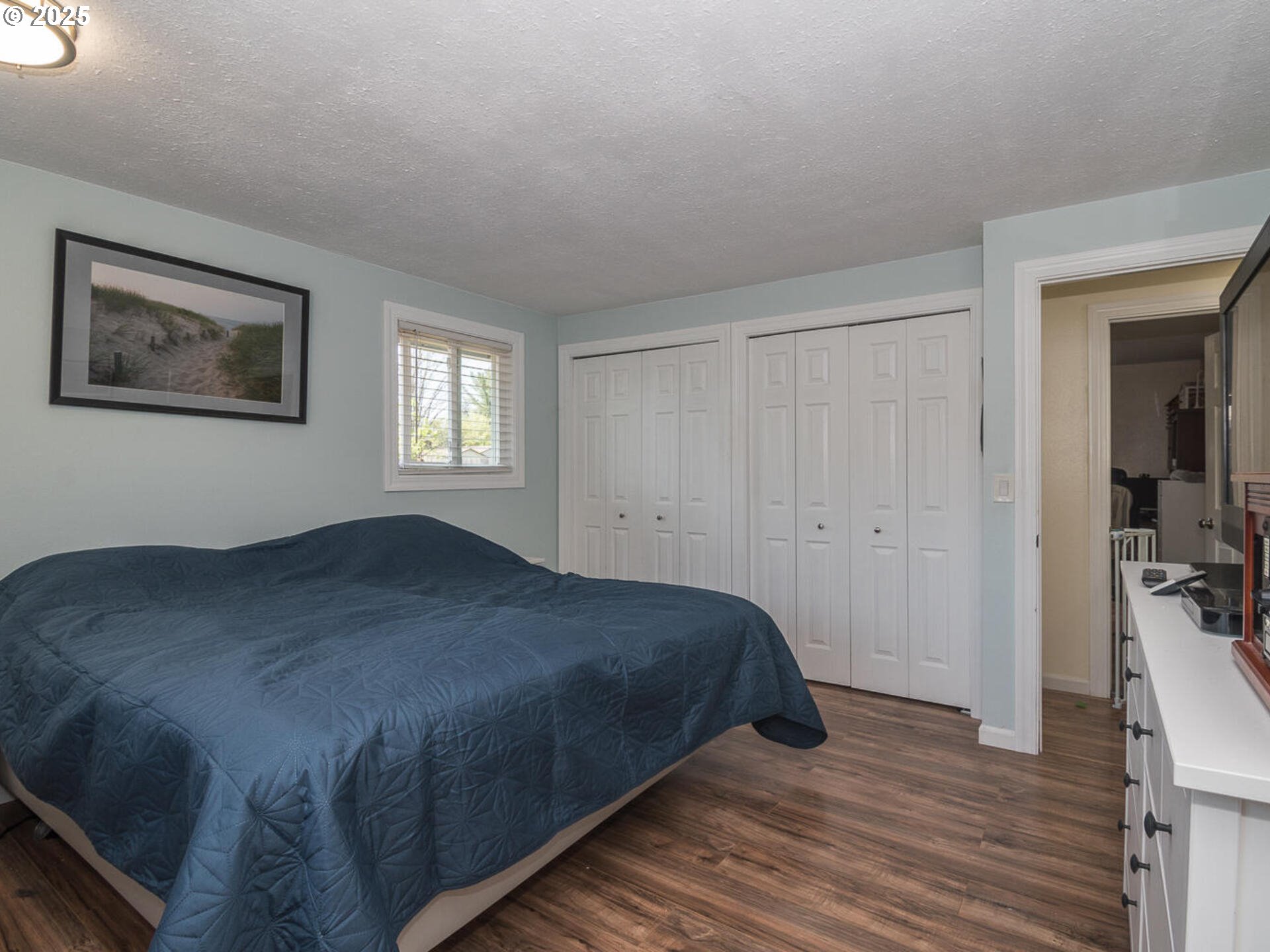 2548 Southeast Eagle Avenue Gresham, OR 97080 - Photo 27 of 32 a bedroom with a bed and wooden floor
