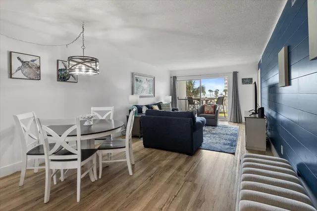 a living room with furniture a couch and wooden floor