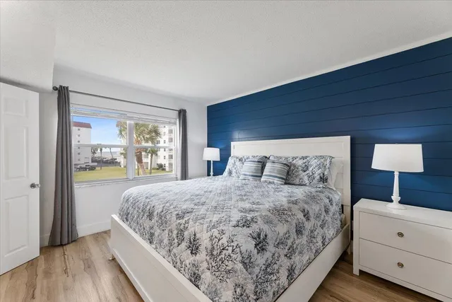 a bedroom with a large bed and a window