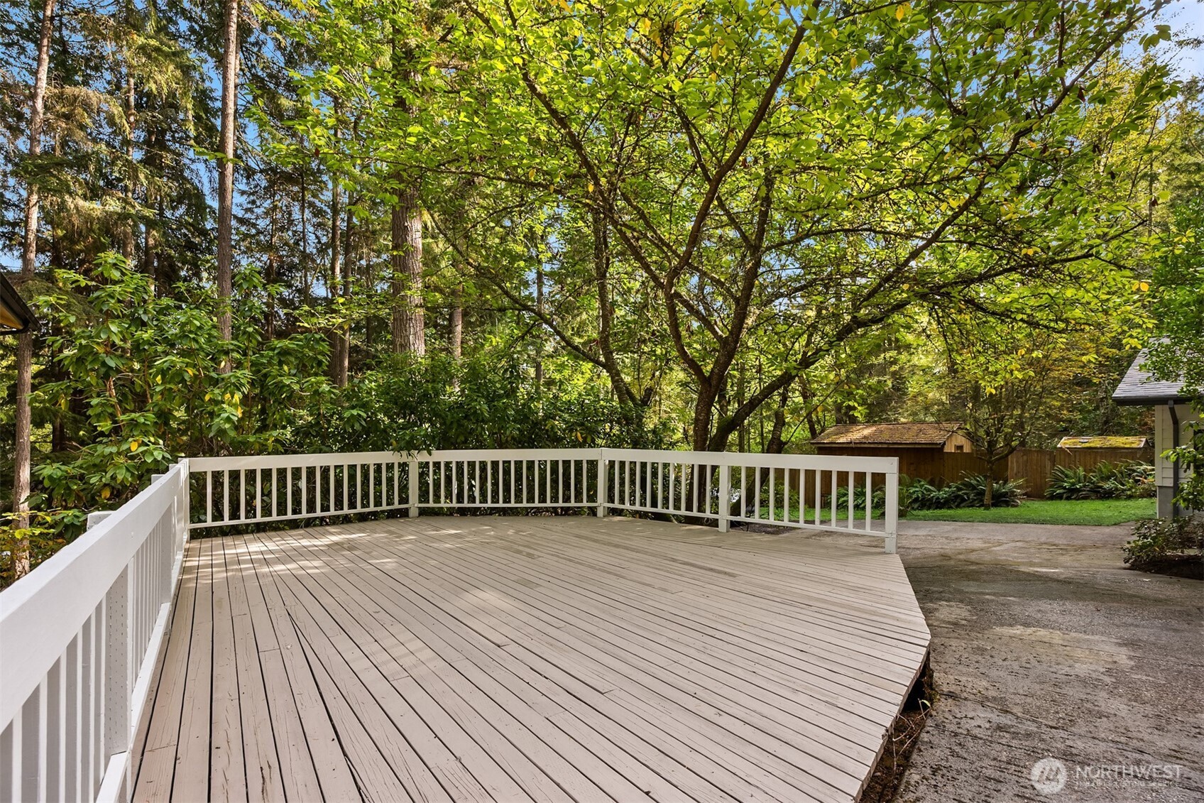 5981 Lynwood Center Road Northeast Bainbridge Island, WA 98110 - Photo 27 of 33 a view of balcony with wooden floor and fence