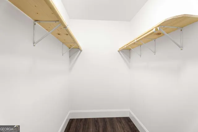 a view of walk in closet with clothes