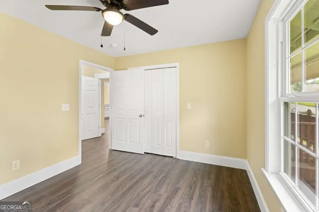 wooden floor in an empty room with a window
