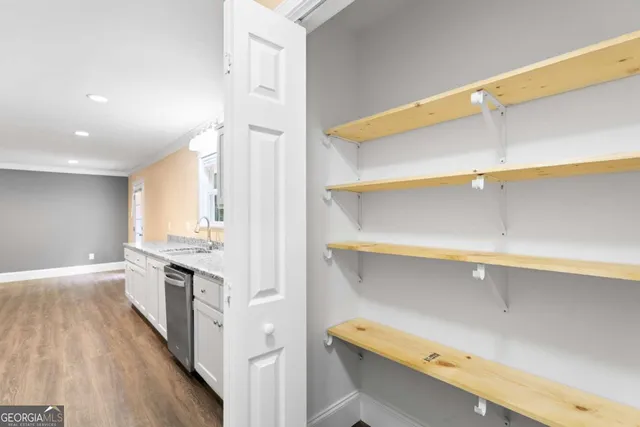 a kitchen with a sink a stove and cabinets