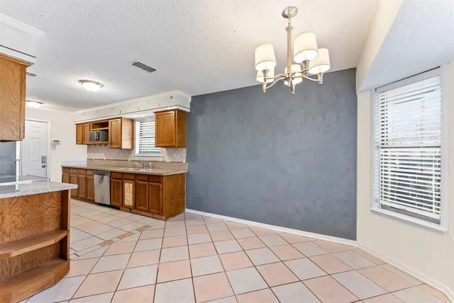 a spacious bathroom with a double vanity sink a mirror and a bathtub