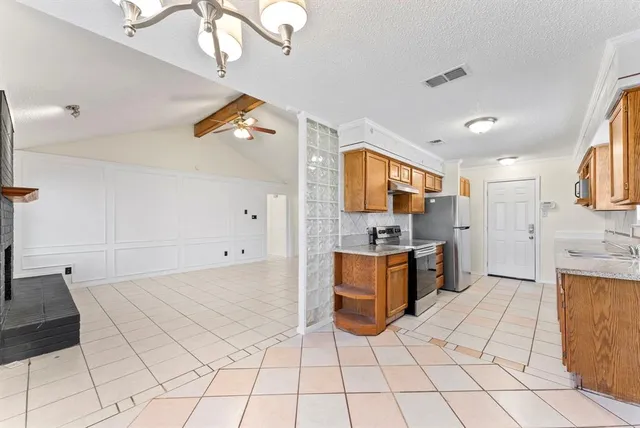a kitchen with stainless steel appliances a stove top oven and cabinets